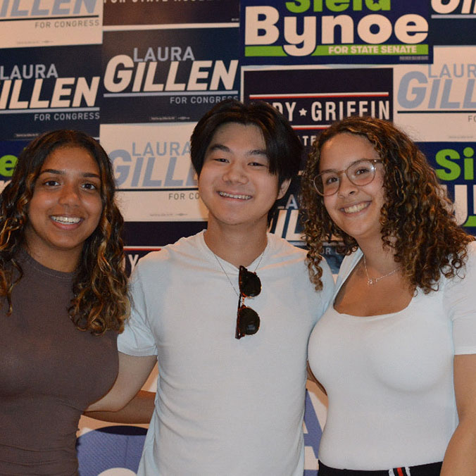 Volunteers in front of signs