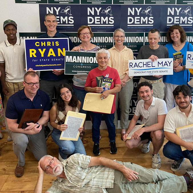 Volunteers with signs inside