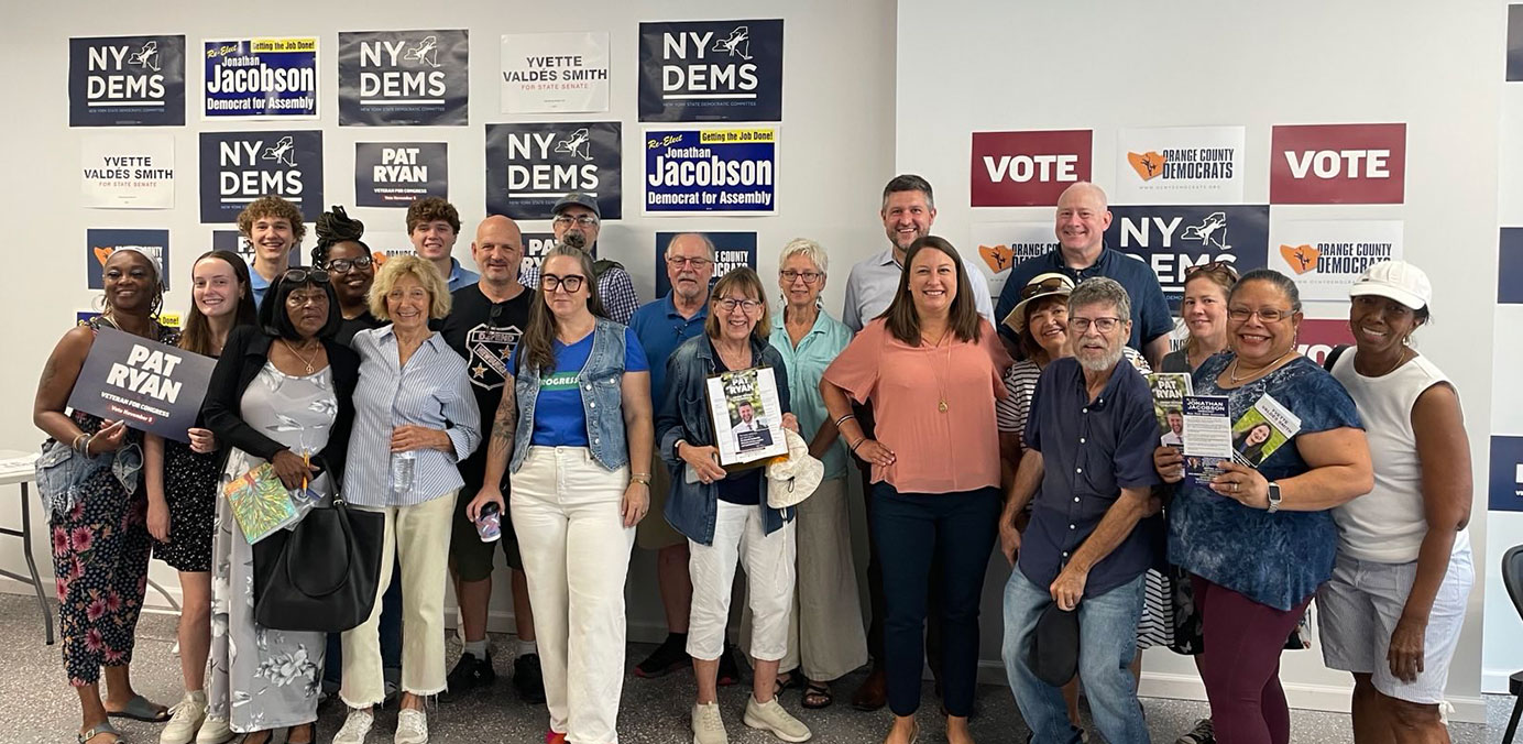 Volunteers in front of signs