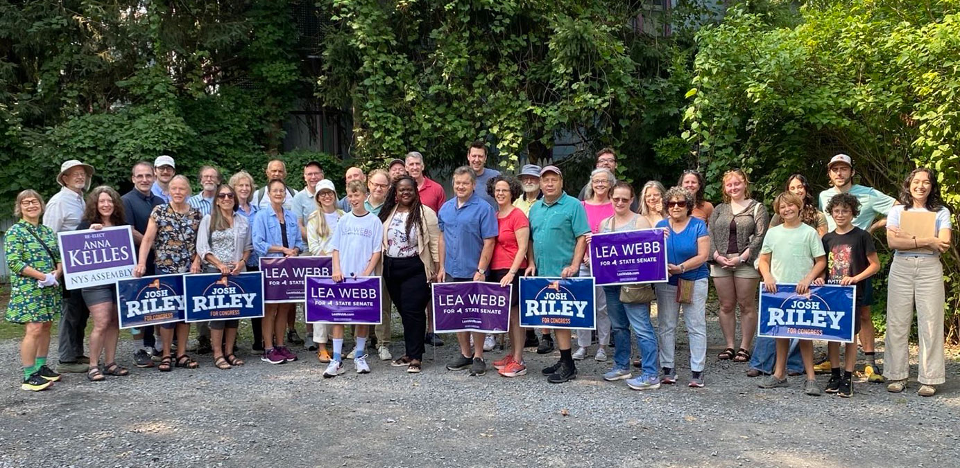 Volunteers with signs outside