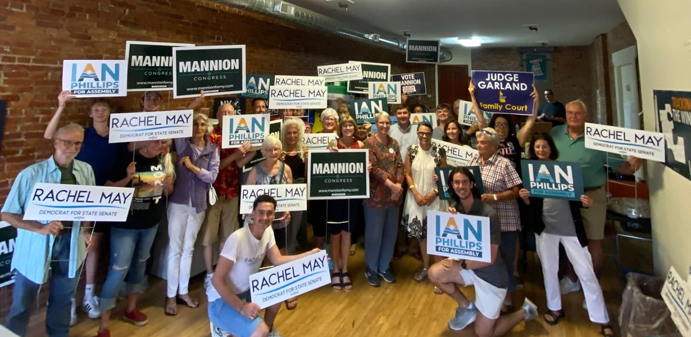 Volunteers with signs outside